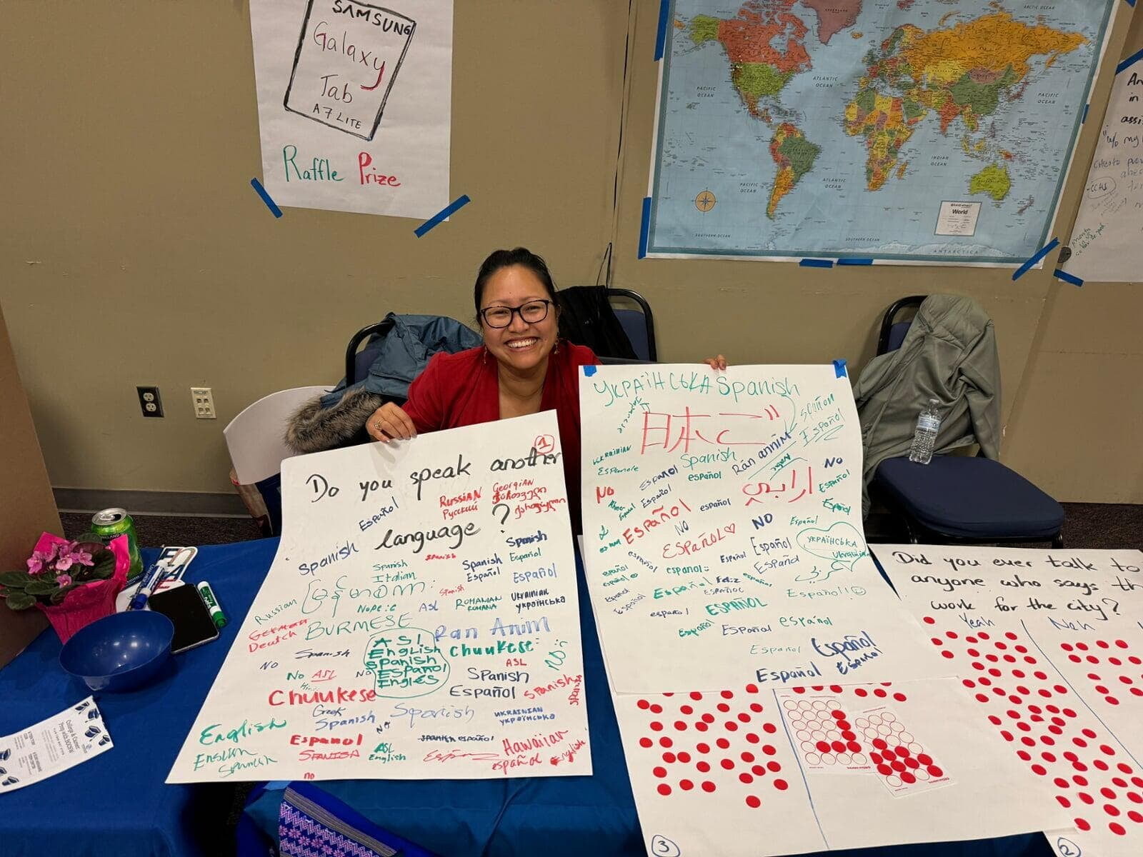 Charis at a community engagement event with language signs